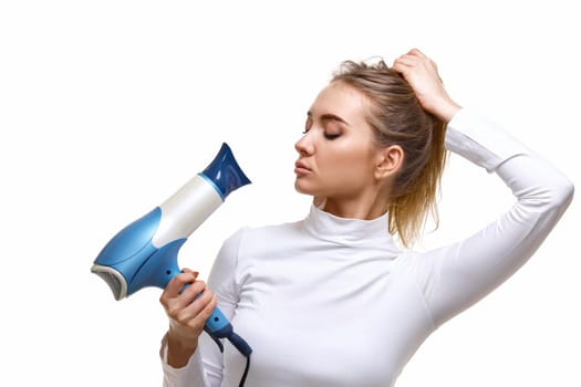 Portrait of attractive cheerful girl holding hair dryer isolated on white background