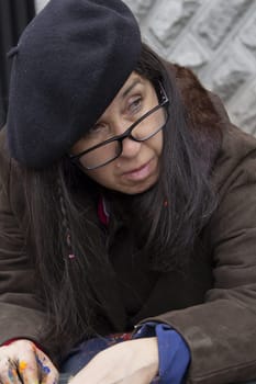 closeup of frustrated bohemian female painter abandoned in the street. High quality photo