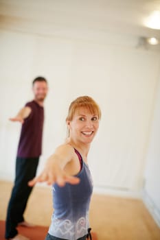 She always looks forward to yoga class. a woman during a yoga class