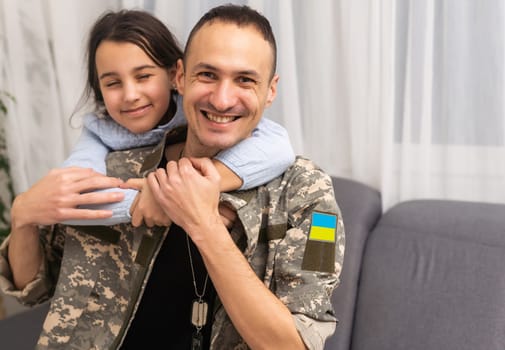 Father in Ukrainian military uniform and his daughter. Family reunion.