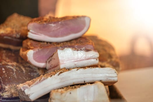 Smoked ham with cured bacon. Hams and bacon are ready for sale at the market. There are labels on them High quality photo