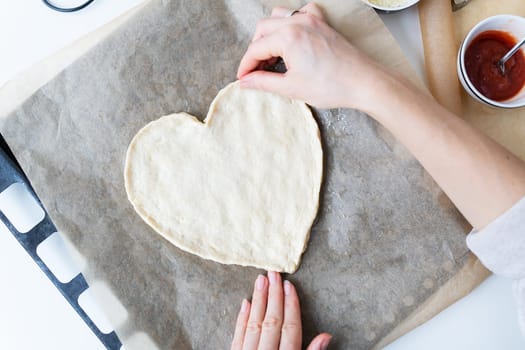 Pizza in the shape of a heart. Romantic valentine's day menu concept for restaurant or delivery