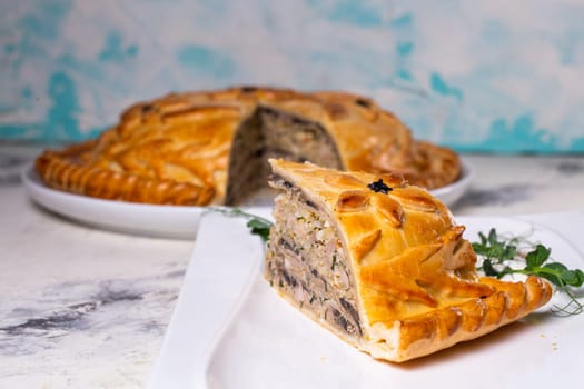 delicious homemade pie with minced meat and potatoes on a white plate.