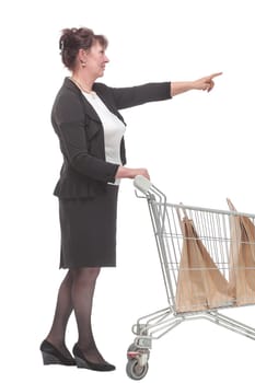 Full length portrait of a woman pushing a shopping trolley isolated on white background