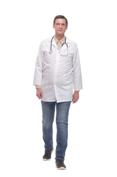 Full length portrait of young caucasian with stethoscope walking doctor isolated on white