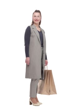 in full growth. attractive woman with a shopping bag .isolated on a white background.