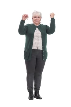 Happy mature business woman holding key against white background and thumb up