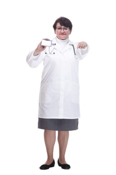 in full growth. senior female medic showing her visiting card. isolated on a white background.