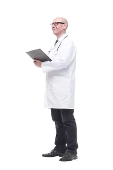 in full growth. senior doctor with clipboard. isolated on a white background.