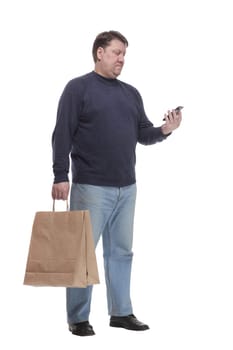 in full growth. casual man with a smartphone .isolated on a white background.