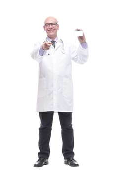 in full growth.smiling doctor showing his business card. isolated on a white background.
