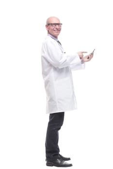 in full growth. doctor with a smartphone. isolated on a white background.