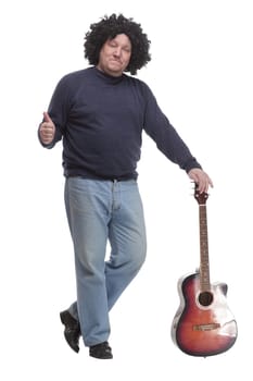 in full growth. curly-haired mature man with a guitar. isolated on a white background.