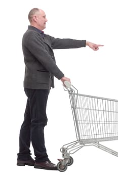 in full growth.smiling casual man with shopping cart .isolated on a white background.