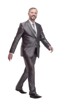 in full growth. confident business man striding forward. isolated on a white background.