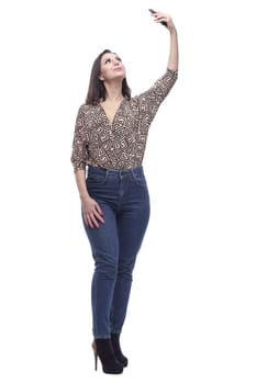 in full growth. attractive young woman with a smartphone. isolated on a white background.
