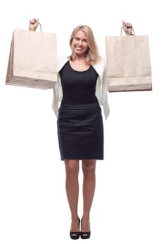 in full growth. happy business woman showing shopping bags. isolated on a white background.