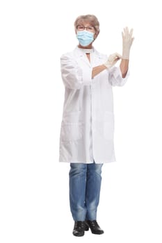 Confident experienced young doctor woman with face mask and gloves isolated on white background. Healthcare personnel, health, medicine concept