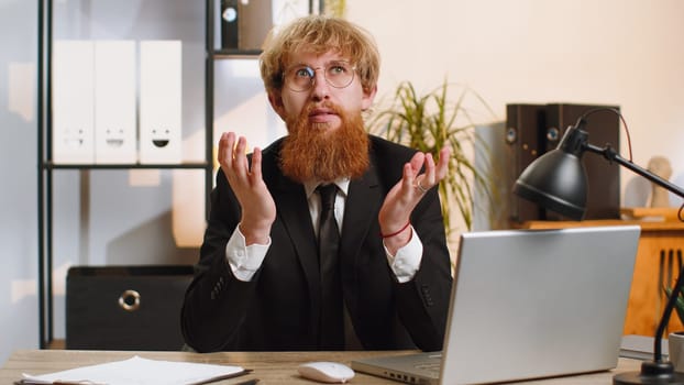Excited amazed businessman working looking shocked surprised wow showing hands brain head explosion gesture, brainstorm, good idea at home office desk workplace. Professional manager freelancer man