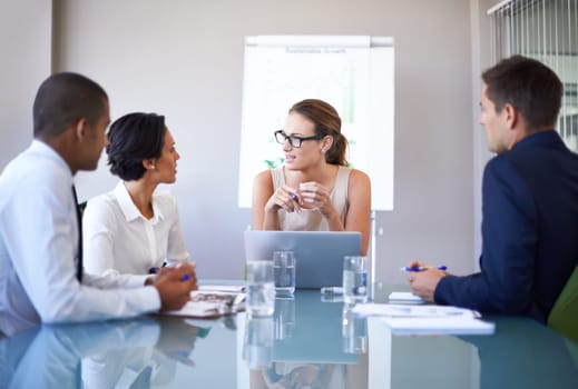 A group of businesspeople having a meeting in a boardroom.