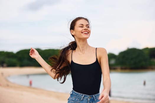 woman smile smiling beach carefree young relax water shore summer body happiness hair travel flight female sea lifestyle sunset running tan