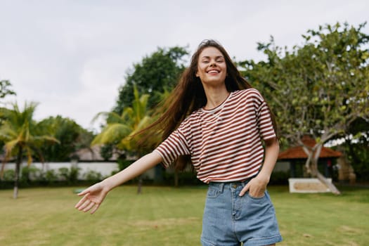 smiling woman walk t-shirt lifestyle female hair person portrait happy park sun walking freedom smile quiet beautiful enjoy girl summer nature long