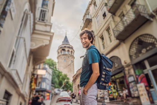 Portrait of man tourist with view of Galata tower in Beyoglu, Istanbul, Turkey. Turkiye.
