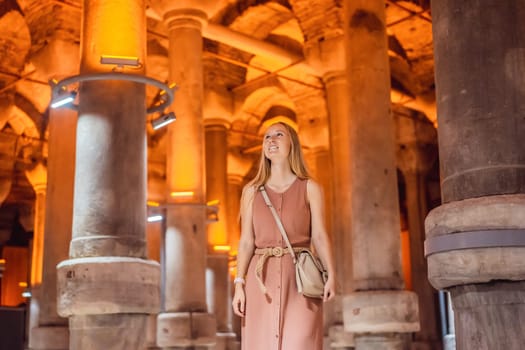 Woman tourist enjoying Beautiful cistern in Istanbul. Cistern - underground water reservoir build in 6th century, Istanbul, Turkey, Turkiye.