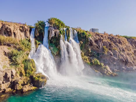 Lower Duden Falls drop off a rocky cliff falling from about 40 m into the Mediterranean Sea in amazing water clouds. Tourism and travel destination photo in Antalya, Turkey. Turkiye