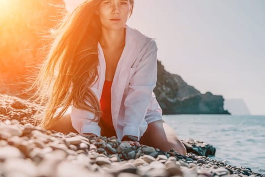 Sexy young woman in stylish bikini lying on seashore, closeup. Holiday, vacation and recreational concept.