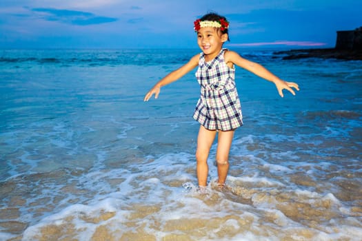 Adorable girl enjoys play time on the beach.