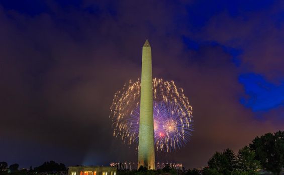 Washington DC, USA - July 04, 2015: Washington Monument stands tall with Fourth of July Fireworks in background.