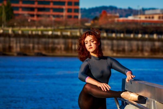 Young female ballet dancer practices at waterfront, Portland downtown.