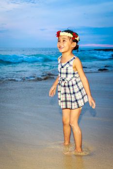 Adorable girl enjoys play time on the beach.