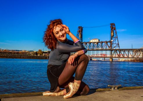 Young female ballet dancer practices at waterfront, Portland downtown.
