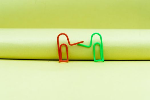 Two businessmen shaking hands. Abstract Human Figure of Paper Clip. Creative Photography. Still Life. Copy Space