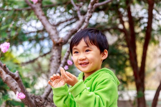 Adorable girl enjoys play time in the woods, smiling.