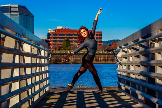 Young female ballet dancer practices at waterfront, Portland downtown.