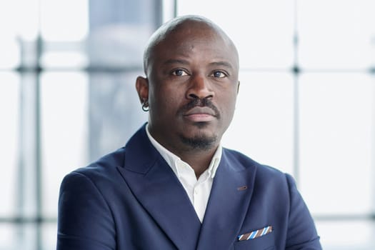Handsome african american executive businessman in the office close up
