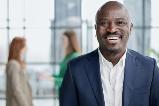 Handsome african american executive businessman in the office close up