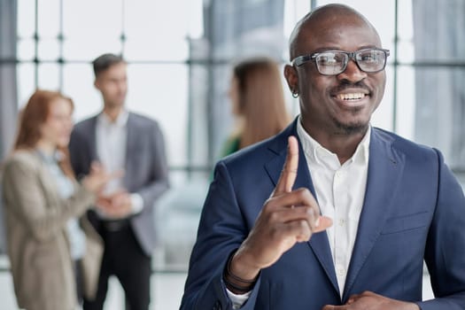 Handsome african american executive businessman in the office close up