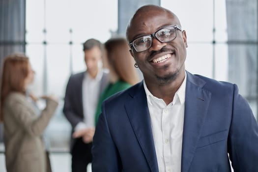 Handsome african american executive businessman in the office close up