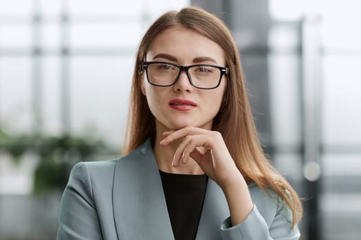Portrait of a confident young businesswoman standing with her arms crossed in an office.