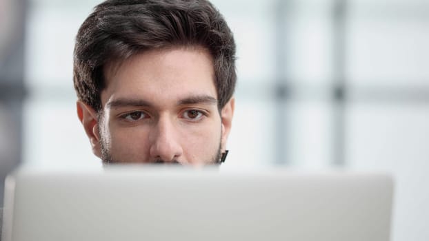 focused young businessman looking at computer monitor