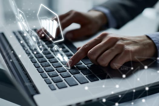 man's hands typing on laptop keyboard in interior