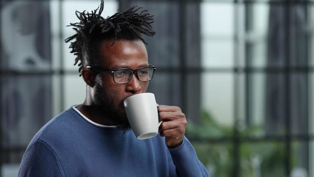 Portrait of a young businessman with a cup of coffee, in casual clothes