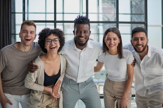 Portrait of successful creative business team looking at camera and smiling. Diverse business people standing together at startup.