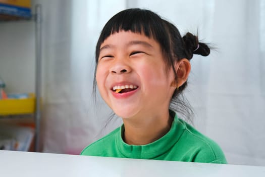 Happy cute little girl eating gelatin candy. Funny kid with chewing gum. Beautiful little girl with with vitamins for children like jelly candy.