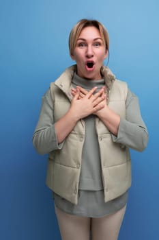 shocked 30 year old blond woman in casual clothes with emotions on her face.