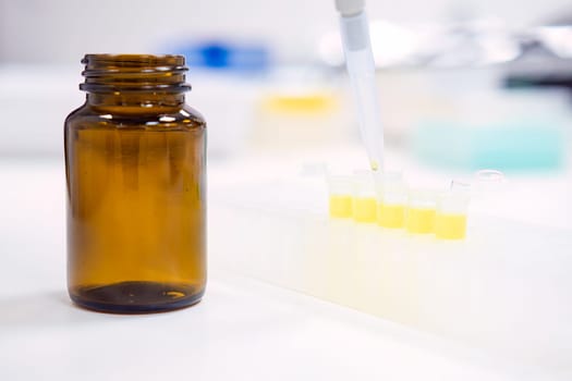Chemical laboratory. Filling stock reagents with an automatic pipette.